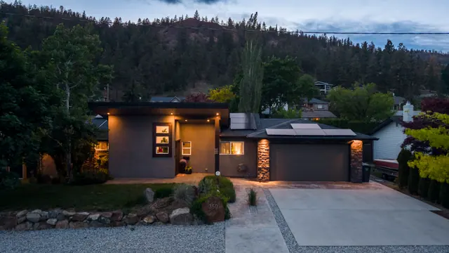 Front exterior dusk, modern home with pool in Glenmore, Kelowna, BC. Real estate photography by Pixel Pro Productions.