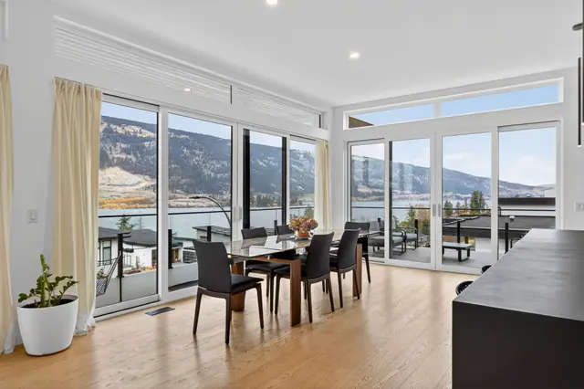 Dining lake view, modern lake-view home in Lake Country, BC. Real estate photography by Pixel Pro Productions.
