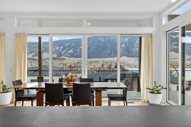 Dining room, modern lake-view home in Lake Country, BC. Real estate photography by Pixel Pro Productions.