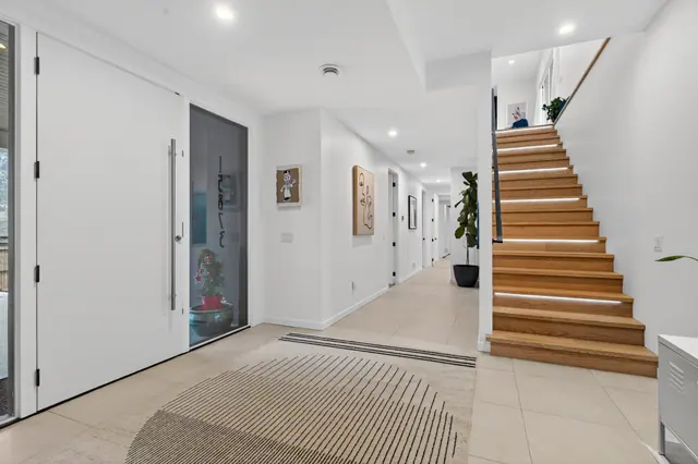 Entry staircase, modern lake-view home in Lake Country, BC. Real estate photography by Pixel Pro Productions.