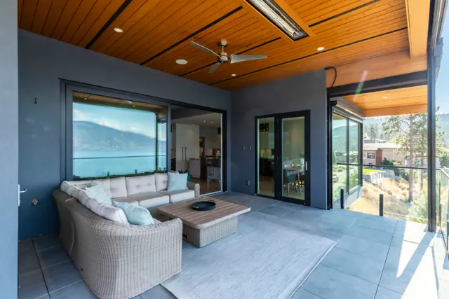 Covered patio, lake-view modern home in Lakestone, Lake Country, BC. Real estate photography by Pixel Pro Productions.