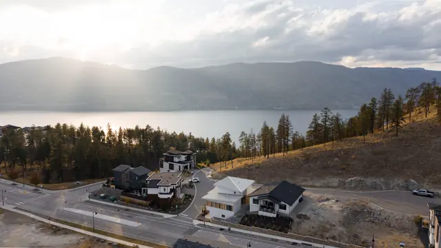 Aerial view sunlight, modern new build in McKinley Beach, Kelowna, BC. Real estate photography by Pixel Pro Productions.