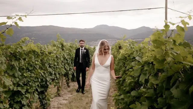 Vineyard walk: Emily & Connor's wedding at 50th Parallel Estate, Lake Country. Still from the Pixel Pro wedding film.