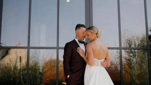 Glass wall portrait: Carlee & Ryan's wedding at CedarCreek Estate Winery, Kelowna. Still from the Pixel Pro wedding film.