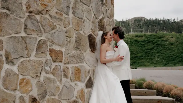 Stone wall portrait: Catherine & Matt's wedding at Chateau Okanagan, Kelowna. Still from the Pixel Pro wedding film.