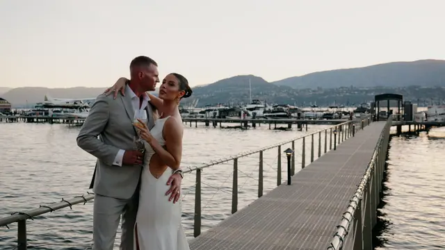 Dock kiss: Bronte & Brett's wedding at Manteo Resort, Kelowna. Still from the Pixel Pro wedding film.