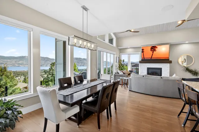 Dining living lake view, lake-view family home in West Kelowna, BC. Real estate photography by Pixel Pro Productions.