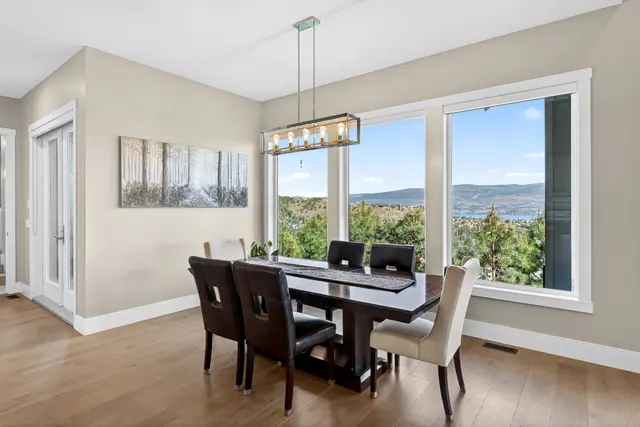 Dining room, lake-view family home in West Kelowna, BC. Real estate photography by Pixel Pro Productions.