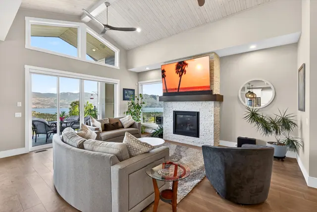 Living room, lake-view family home in West Kelowna, BC. Real estate photography by Pixel Pro Productions.