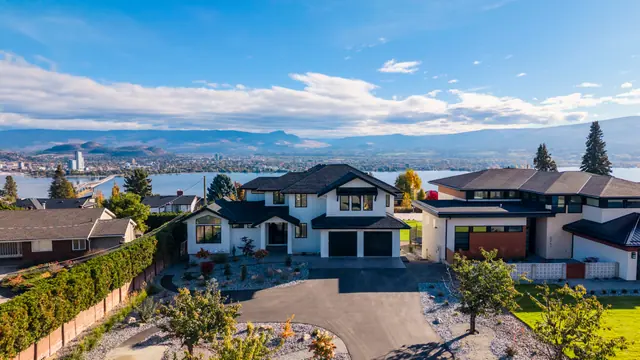 Aerial view neighbourhood, new-build lake-view home in West Kelowna, BC. Real estate photography by Pixel Pro Productions.